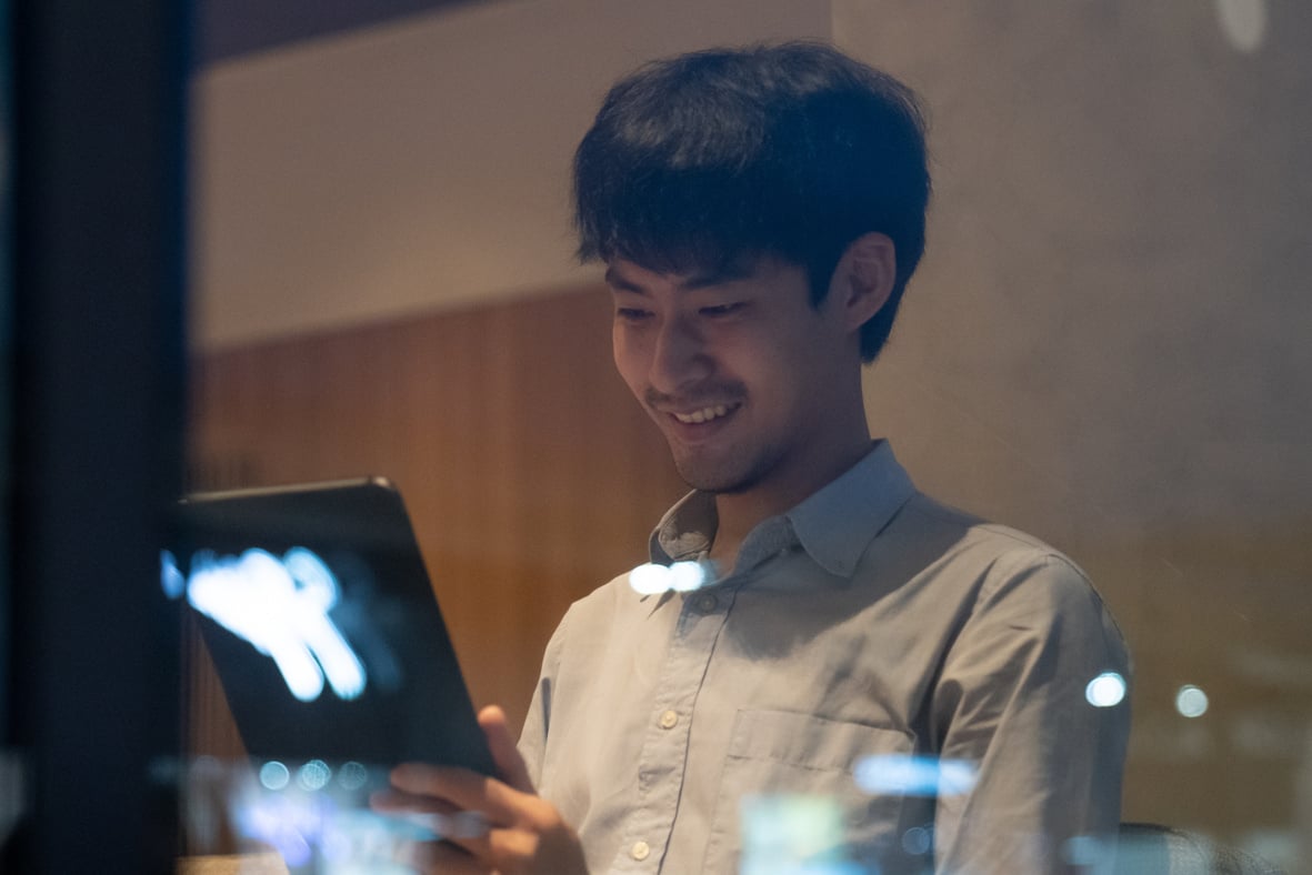 Businessman having Zoom video conferencing call via tablet.