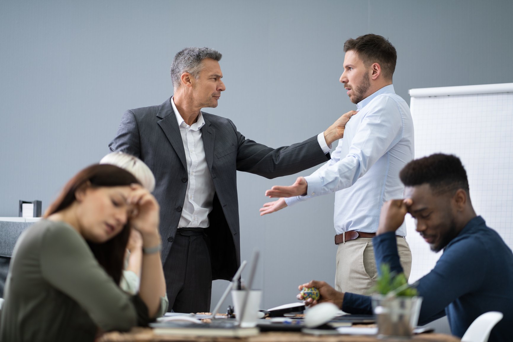 Two Male Colleagues Fighting In Office